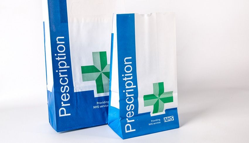 Two NHS prescription bags with blue and white design, featuring a green pharmacy cross symbol.